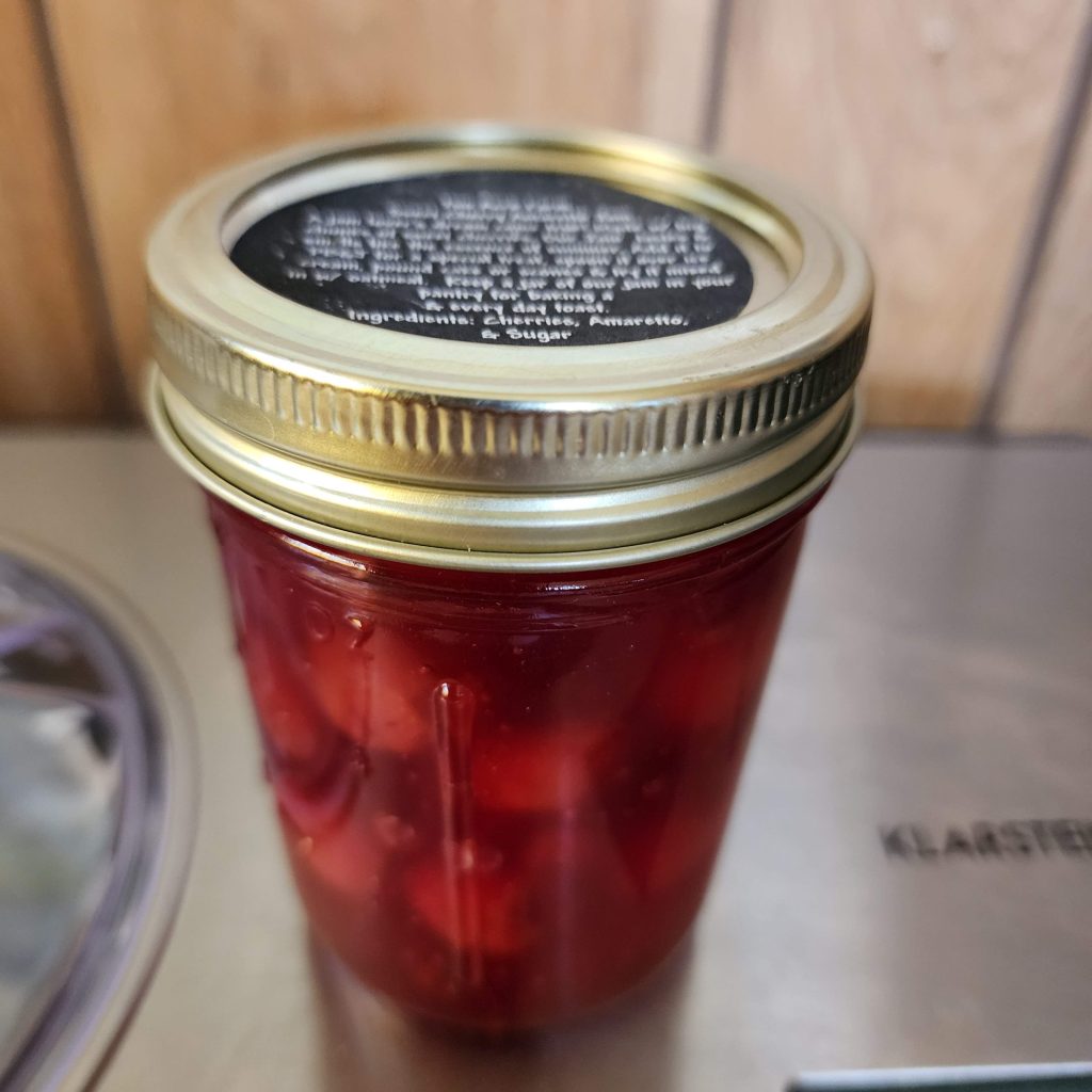 Jar of canned sweet cherries in jelly from Two Acre Brinery
