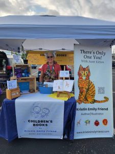 Kristin (Aunt Kitten) selling her book, There's Only One You with Aunt Kitten and amigarumi loveys at the Uniontown Farmers Market.